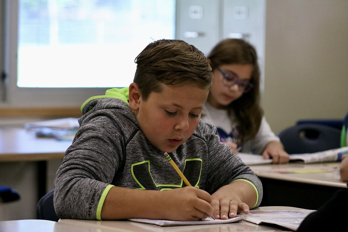 Ten year old Dallen Wilding, a fifth grader at Twin Lakes Elementary school, works on his submission to Kid Scoop Weekly Writing Corner, a section of the newspaper where kids can submit a response to a weekly writing prompt with the possibility of getting published in the next issue. HANNAH NEFF/Press