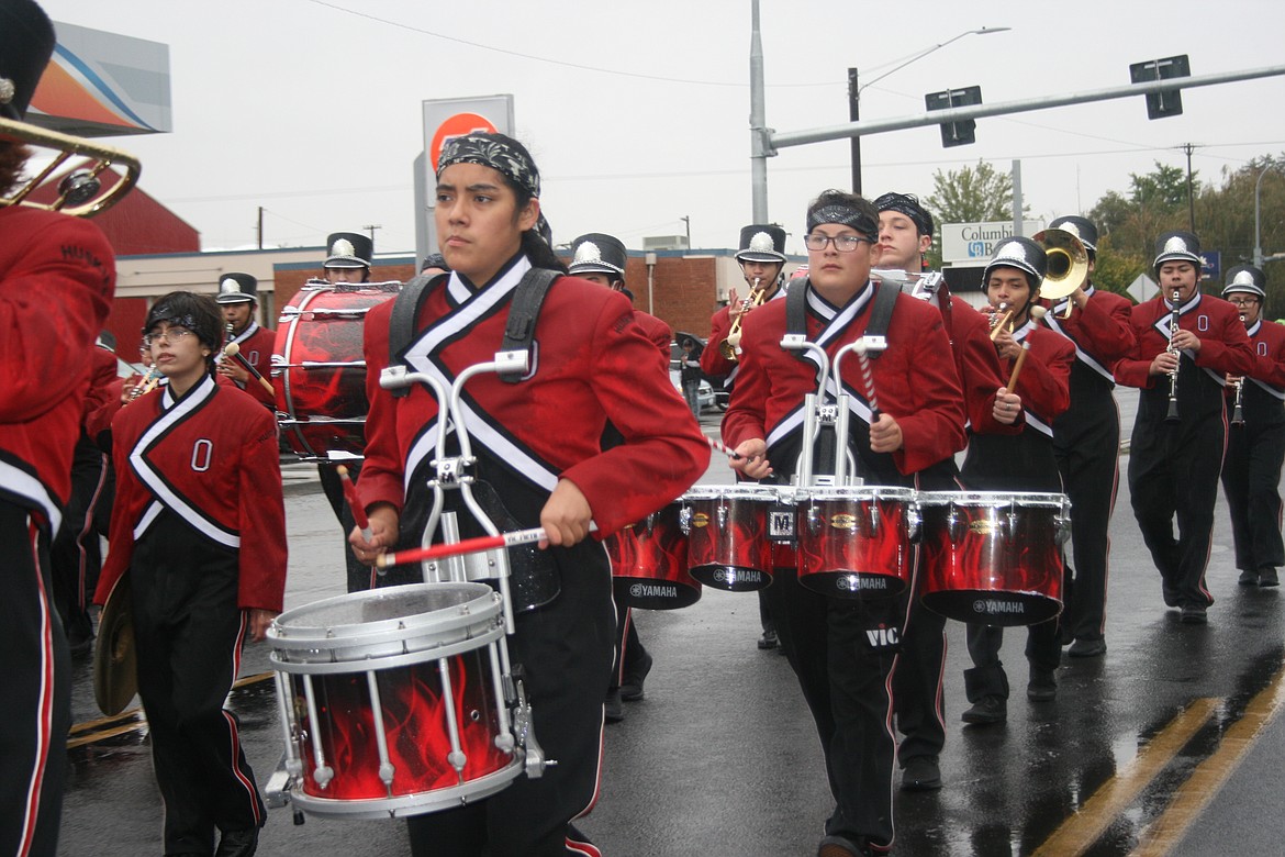 The Othello High School marching band ignored the rain and performed the music during the Othello Fair parade Saturday.