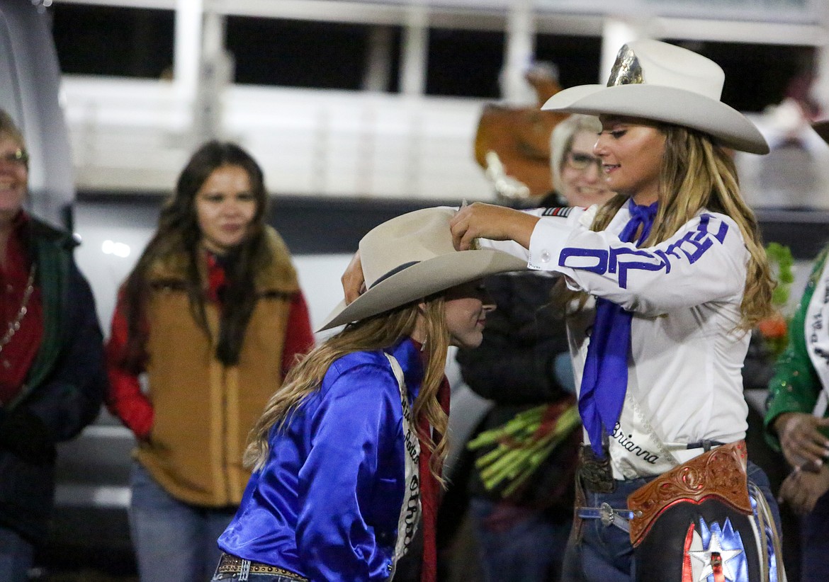 Miss Rodeo Othello 2020-21 Brianna Kin Kade passes the torch to incoming 2022 Miss Rodeo Othello Lexi Hagins on Saturday night at the Othello PRCA Rodeo.