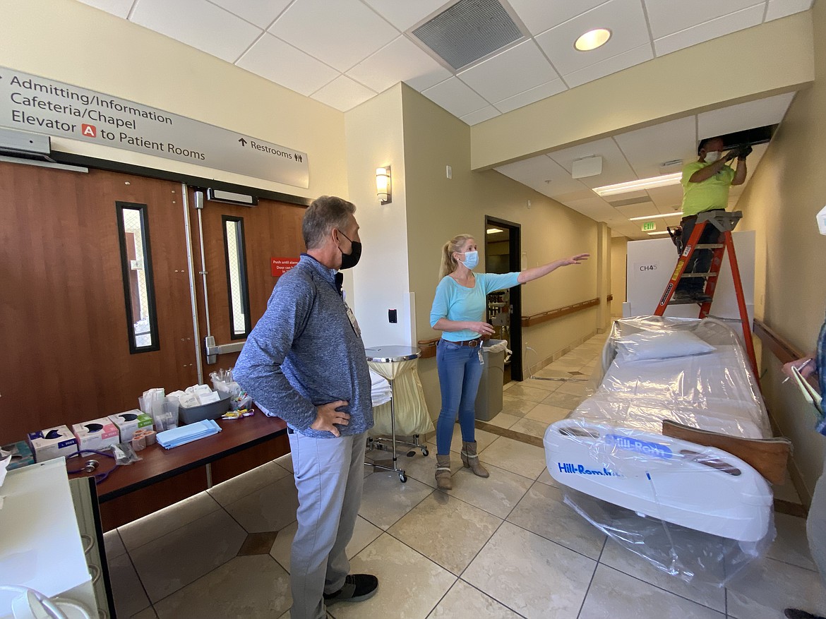 Billings Clinic emergency department manager Brad Von Bergen and Dr. Jaimee Belsky discuss options for additional space in a hallway there on Sept. 17. The hospital’s intensive care unit was operating at 160% capacity that day. (Billings Clinic)