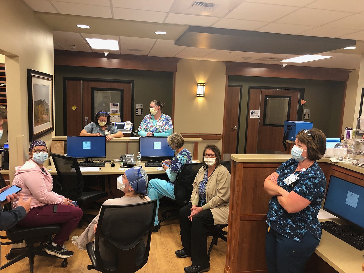Christy Baxter (far right), director of critical care at Billings Clinic, meets with nurses in the hospital’s cardiopulmonary unit on Sept. 17. The unit houses overflow patients from the ICU. (Nick Ehli for KHN)