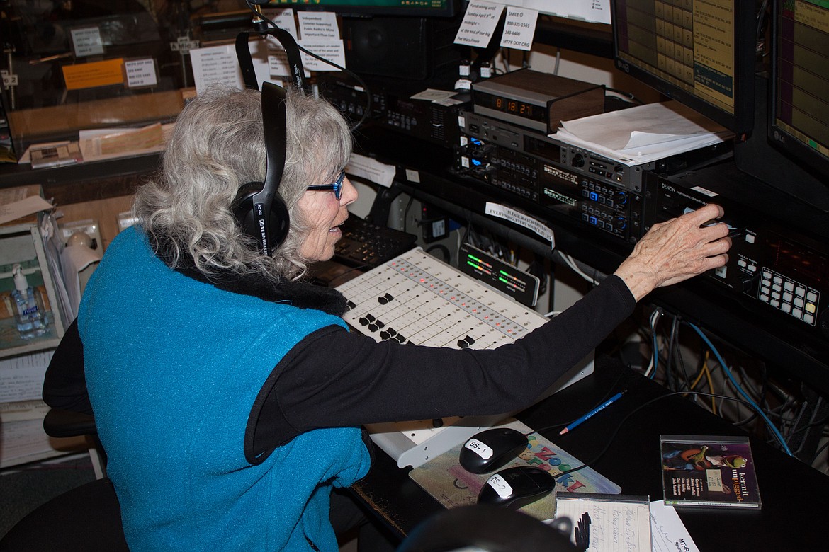 Annie Garde runs the Montana Public Radio Control board while hosting her children's program "The Pea Green Boat." (Courtesy Montana Public Radio)