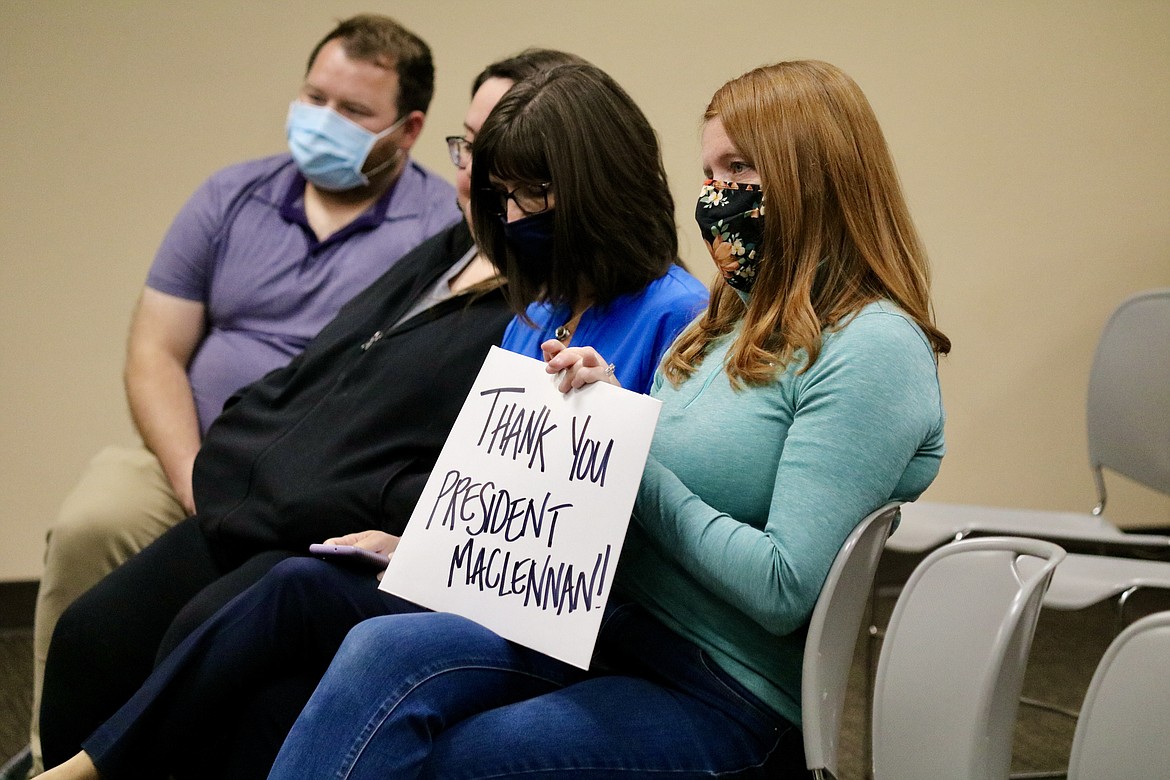 Teresa Borrenpohl, enrollment service center manager for North Idaho College, shows her support for college President Rick MacLennan at the board meeting Wednesday night during which his contract was terminated as of the end of day today. HANNAH NEFF/Press