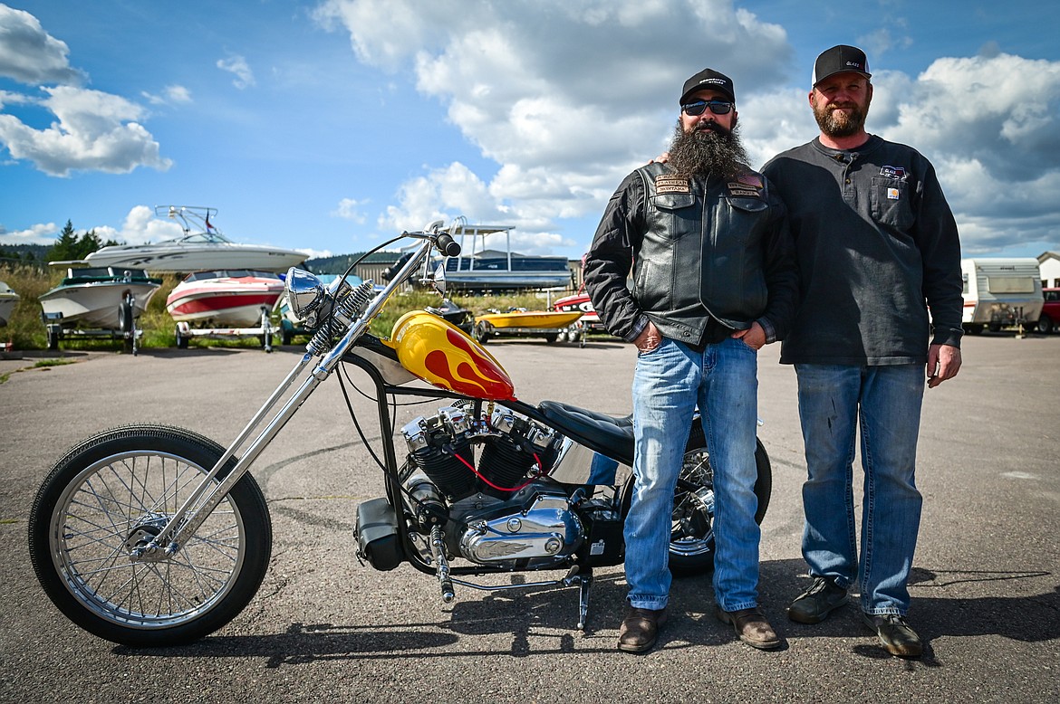 Jeff Peterson, left, of Bodhisattva Cycles, and Nate Gebhart, of Kalispell, stand with the custom 1972 Harley Davidson Ironhead Peterson built and Gebhart won in a fundraiser held by the Veterans Coalition of Northwest Montana to raise money for a Question, Persuade and Refer suicide awareness program for veterans.