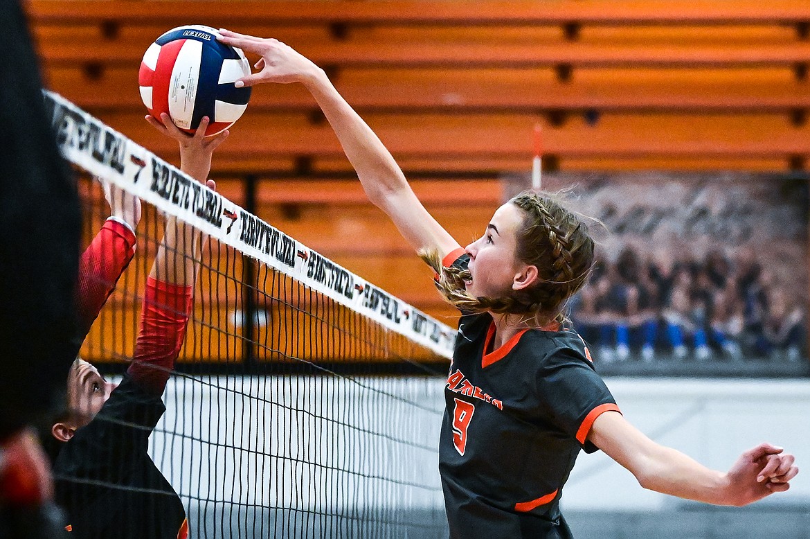 Flathead's Kennedy Moore (9) stuffs an attack at the net by Missoula Hellgate at Flathead High School on Thursday, Sept. 23. (Casey Kreider/Daily Inter Lake)