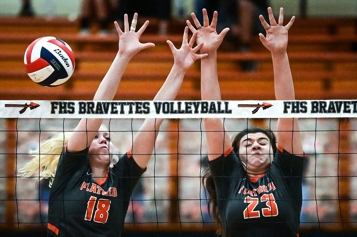 Flathead's Maddy Moy (18) and Savanna Sterck (23) go up for a block against Missoula Hellgate at Flathead High School on Thursday, Sept. 23. (Casey Kreider/Daily Inter Lake)