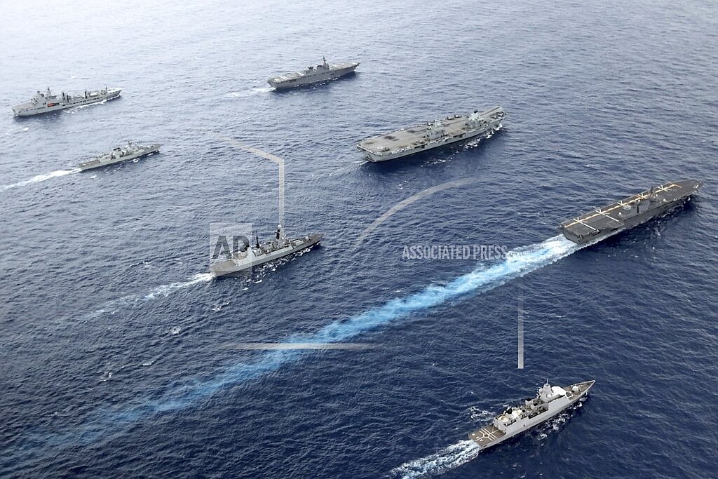 Front to back; HNLMS Evertsen, JS Izumo, HMS Defender, HMS Queen Elizabeth, HMCS Winnipeg, JS Ise, RFA Tidespring. UK Royal Navy Carrier Strike Group 21 HMS Queen Elizabeth, HMS Defender, RFA Tidespring and HNLMS Evertsen from CSG21 sails with Japanese ships JS Izumo and JS Ise along with the Canadian ship HMCS Winnipeg in the Pacific Ocean, Sept. 2021. With increasingly strong talk in support of Taiwan, a new deal to supply Australia with nuclear submarines, and the launch of a European strategy for greater engagement in the Indo-Pacific, the U.S. and its allies are becoming growingly assertive in their approach toward a rising China. (UK Ministry of Defence via AP)