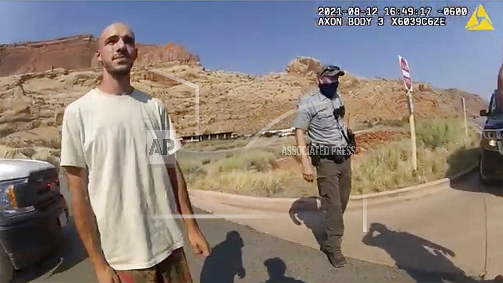 This Aug. 12, 2021 file photo from video provided by The Moab Police Department shows Brian Laundrie talking to a police officer after police pulled over the van he was traveling in with his girlfriend, Gabrielle "Gabby" Petito, near the entrance to Arches National Park. Laundrie, the boyfriend of Gabby Petito, whose body was found at a national park in Wyoming after a cross-country trip with him, has been charged with unauthorized use of a debit card as searchers continue looking for him in Florida swampland, federal authorities announced Thursday, Sept. 23, 2021. (The Moab Police Department via AP, File)