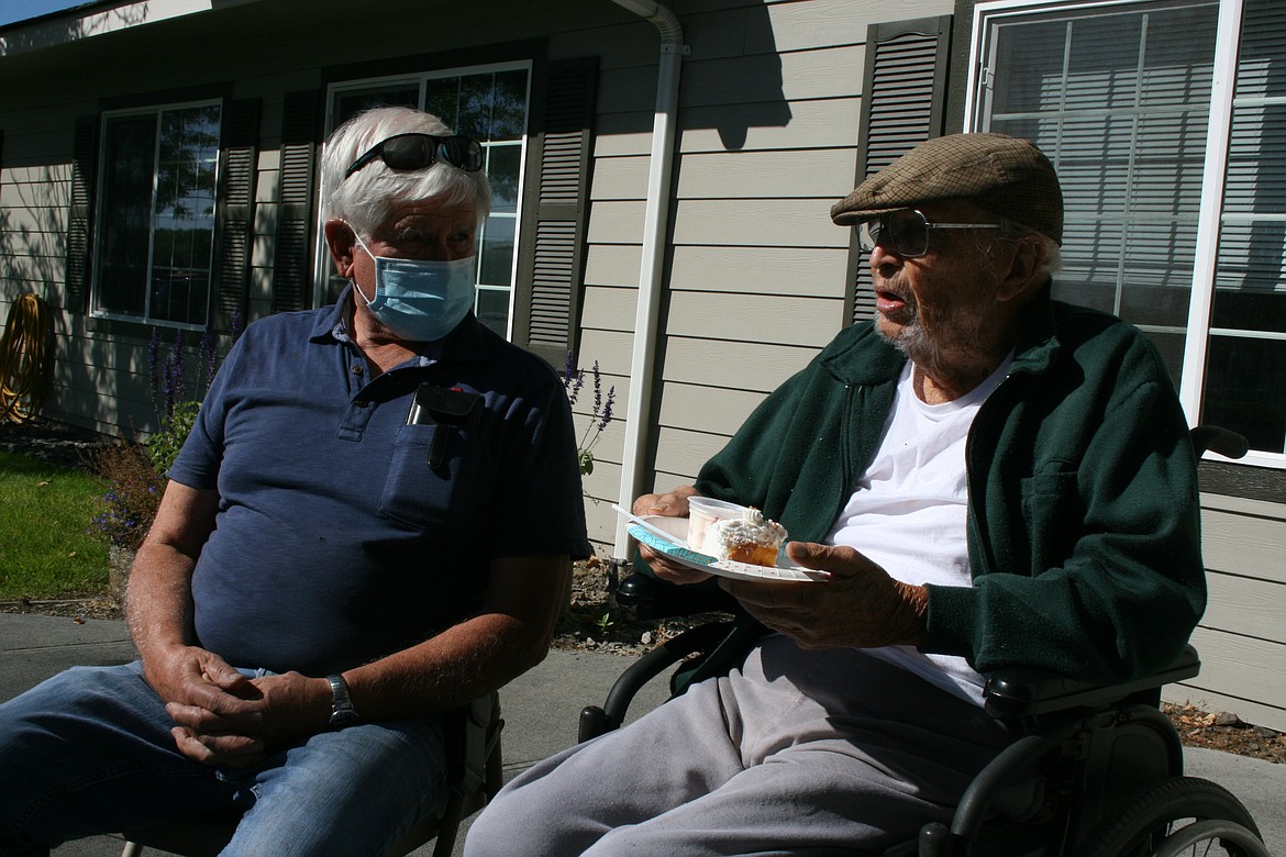Dr. Jim Young (right) chats with friend and neighbor Gene Davis during his 103rd birthday party.