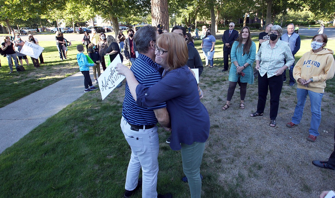 Erin Davis, North Idaho College English professor, gives Rick MacLennan a hug during a show of support by about 100 people on his last day as NIC president on Thursday.