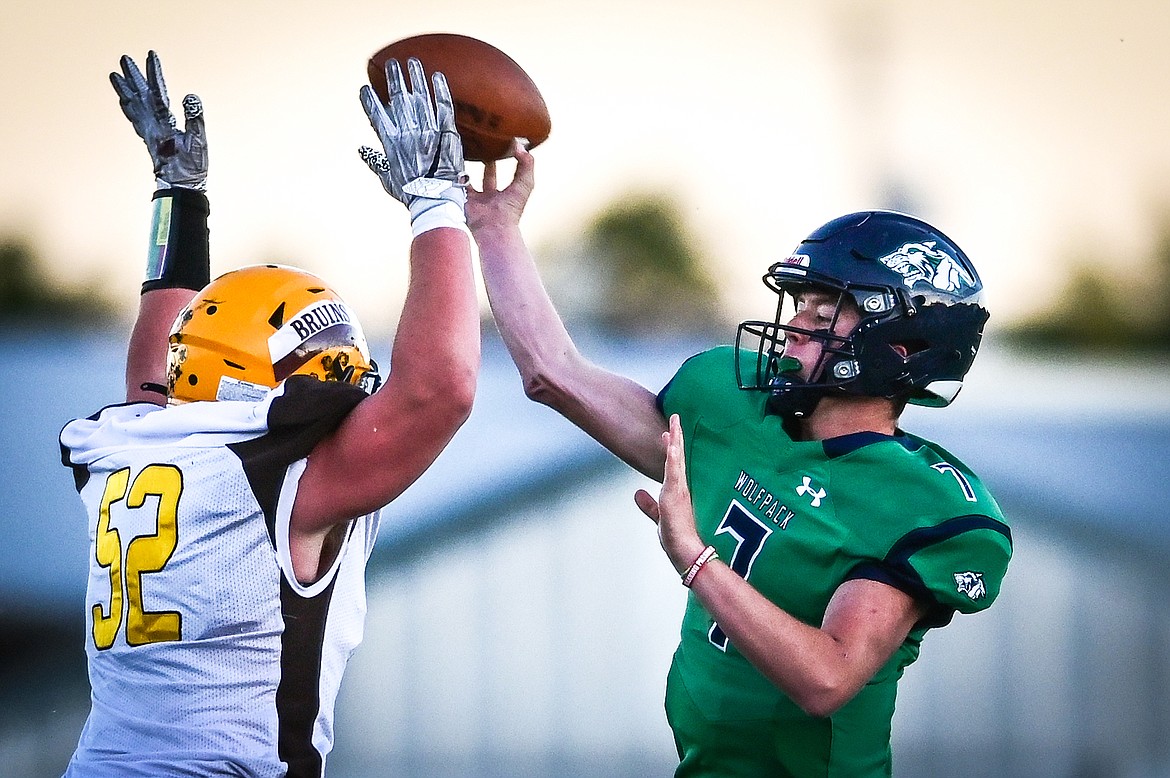 Glacier quarterback Gage Sliter (7) passes under pressure from Helena Capital defensive lineman Talon Marsh (52) in the first quarter at Legends Stadium on Friday, Sept. 24. (Casey Kreider/Daily Inter Lake)