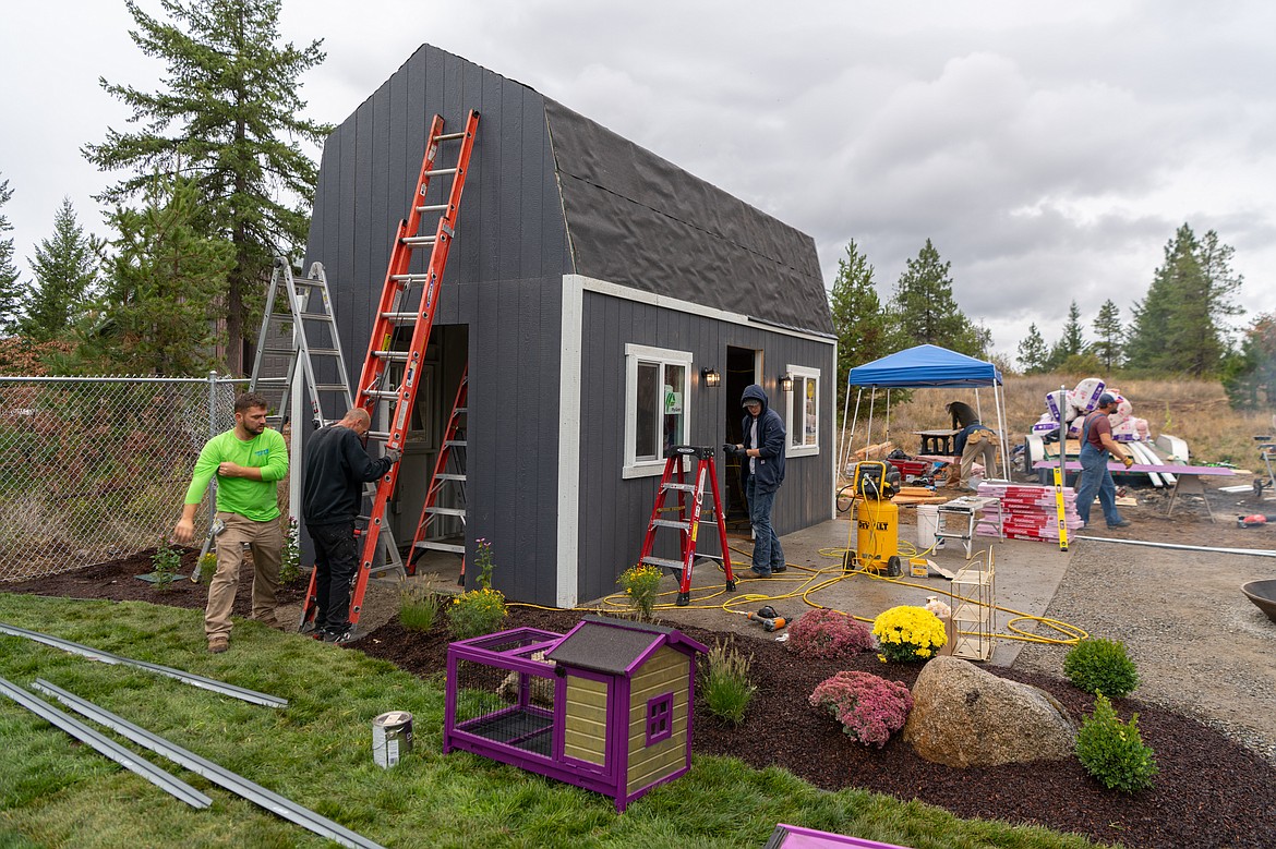 Volunteers and members of the Coeur Group working on the construction of "Harper's Homestead." About twenty volunteers spent three days building the structure in cooperation with the Make-a-Wish Foundation of Idaho.