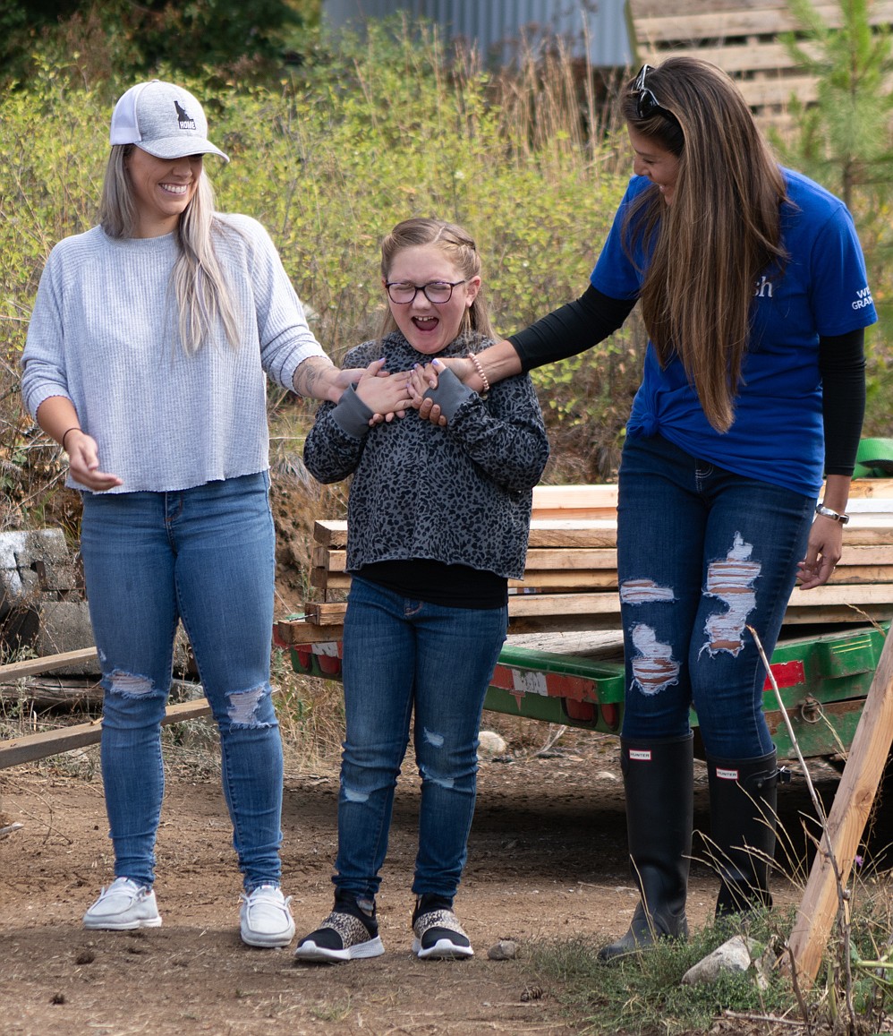Eight-year-old Harper Pursley reacts to seeing "Harper's Homestead" for the first time. Harper's mother Chelsea Pursley on the left and Melissa Menke, a Make-a-Wish granter, member of the Coeur Group and Hagadone Hospitality employee.