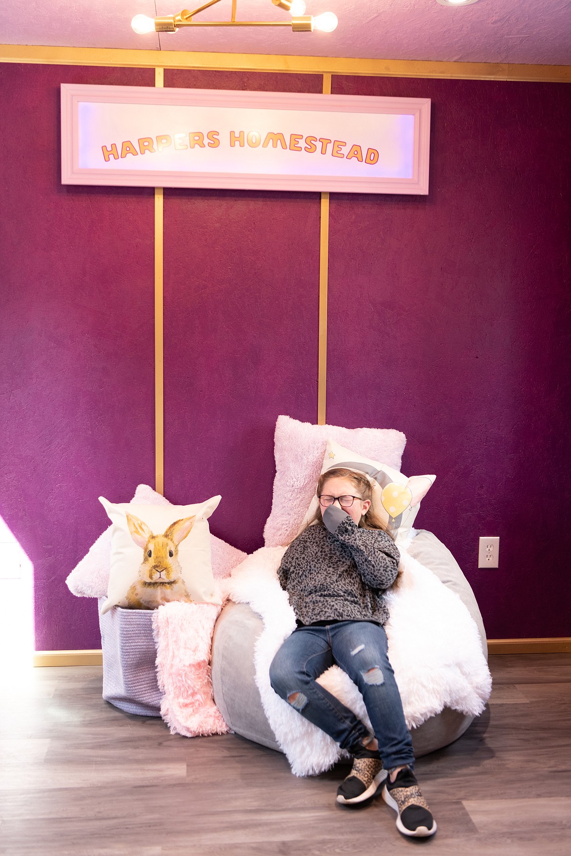Harper Pursley enjoys the interior of her bunny barn. Other than a dwelling for her bunny "Carrots", "Harper's Homestead" includes a cozy lounge area, art supplies, books, lighting and exterior landscaping. Her wish was granted last week by Make-a-Wish Idaho and the Coeur Group.
