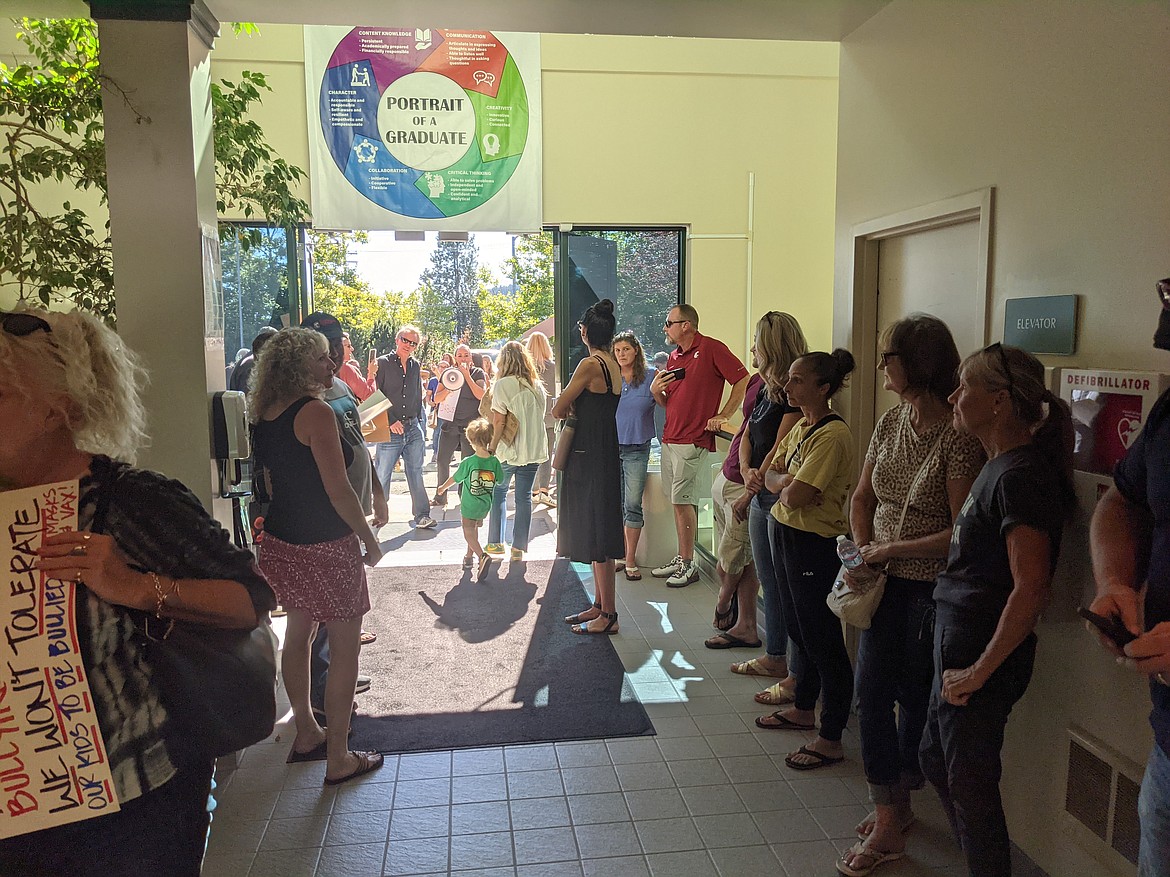 Over 100 protesters swarmed the Coeur d'Alene School District office on Northwest Boulevard Friday. (CHANSE WATSON/Press)