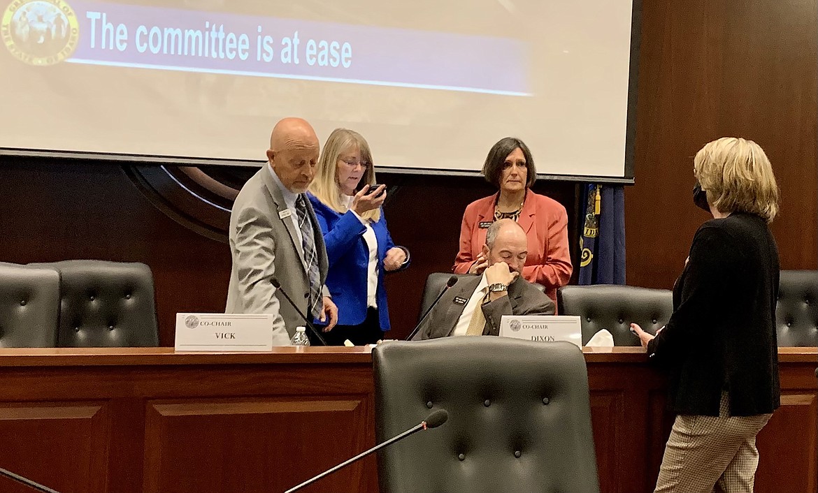 Members of the Idaho Legislature’s Committee on Federalism speak to each other during a break in the meeting on Thursday, Sept. 21, 2021, at the Statehouse in Boise.