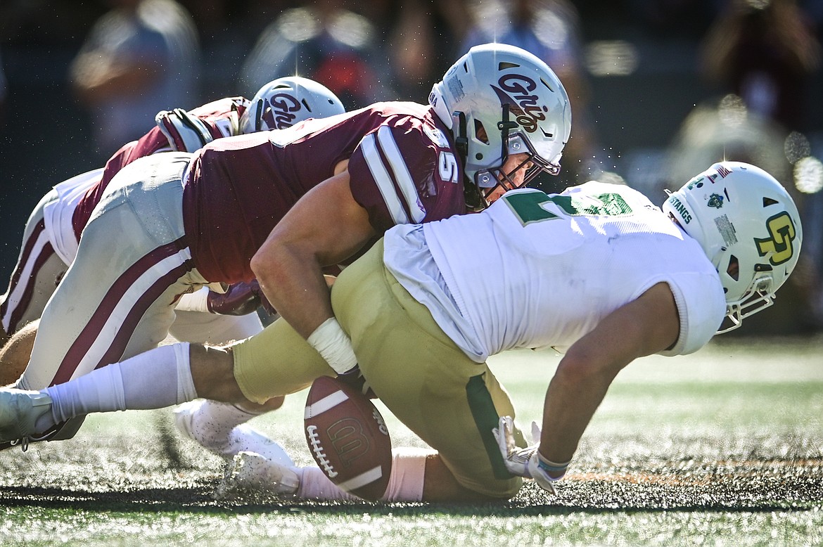 Montana linebacker Braxton Hill (35) tackles Cal Poly punt returner Giancarlo Woods (2) causing a fumble in the fourth quarter at Washington-Grizzly Stadium on Saturday, Sept. 25. (Casey Kreider/Daily Inter Lake)