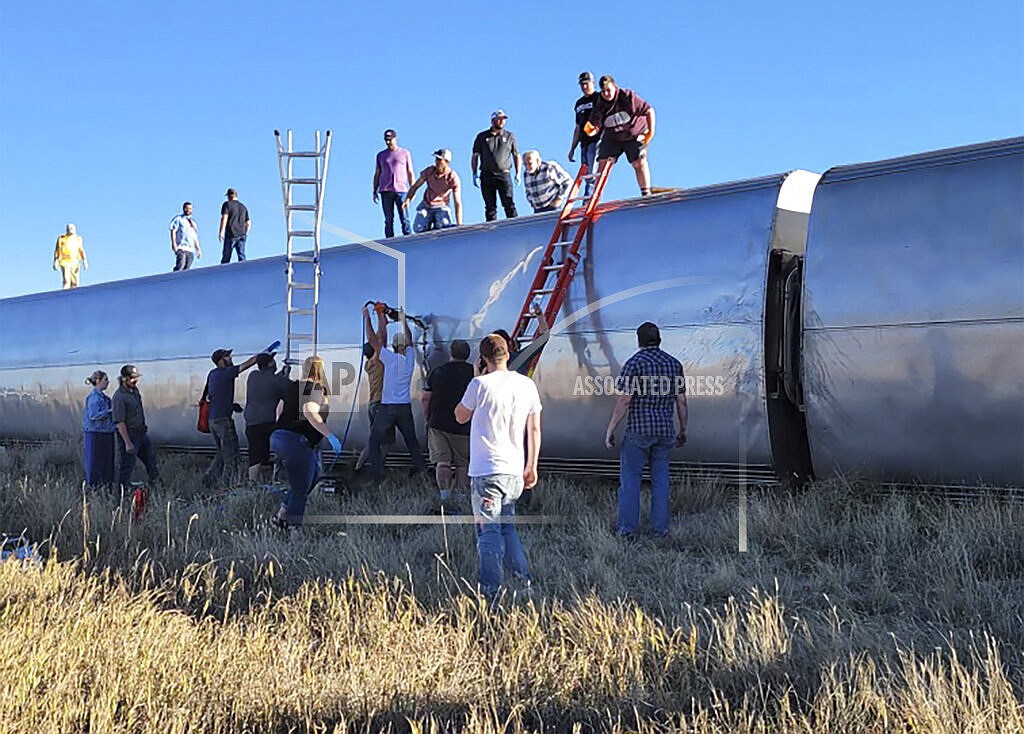 In this photo provided by Kimberly Fossen, people work at the scene of an Amtrak train derailment on Saturday, Sept. 25, 2021, in north-central Montana. At least three people died and multiple people were injured when the train that runs between Seattle and Chicago derailed Saturday, the train agency said. (Kimberly Fossen via AP)