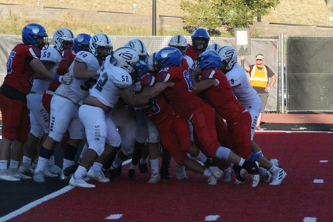 MARK NELKE/Press
Gunner Giulio, center, of Coeur d'Alene is seemingly stopped at the line of scrimmage by Skyview defenders in the third quarter Saturday at Roos Field in Cheney. But, moments later, Giulio — and the pile — wound up in the end zone.