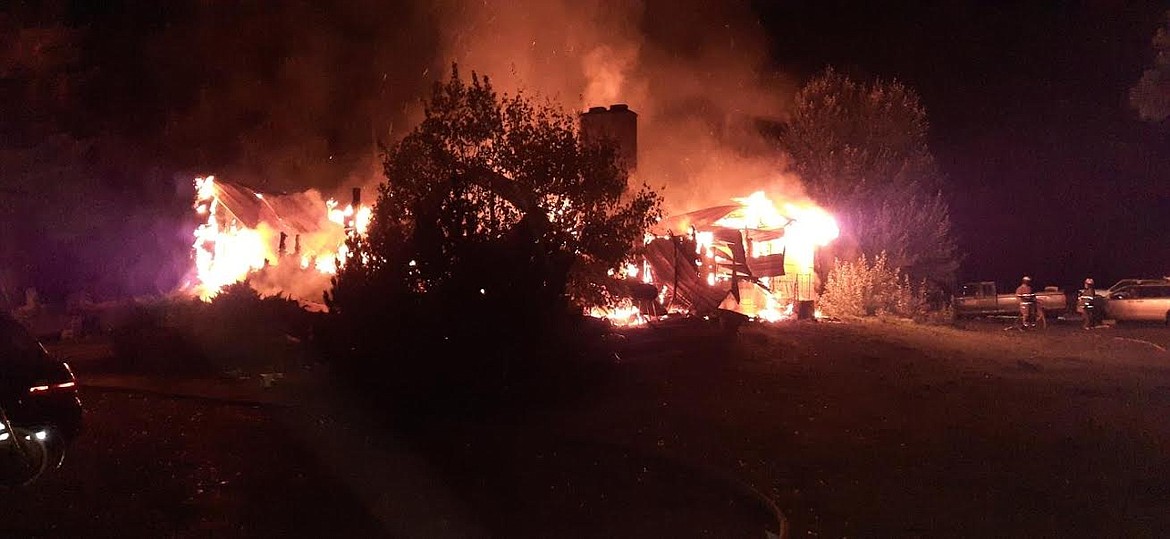 Fire destroyed a St. Regis residence on Sept. 20. Fire crews from St. Regis, Superior, West End and the U.S. Forest Service responded. It is believed someone was transported to the Mineral County Hospital. Officers from the Montana Highway Patrol and Mineral County Sheriff’s Office also assisted at the scene. (Photo courtesy Chuck Anderson, St. Regis Fire Department)