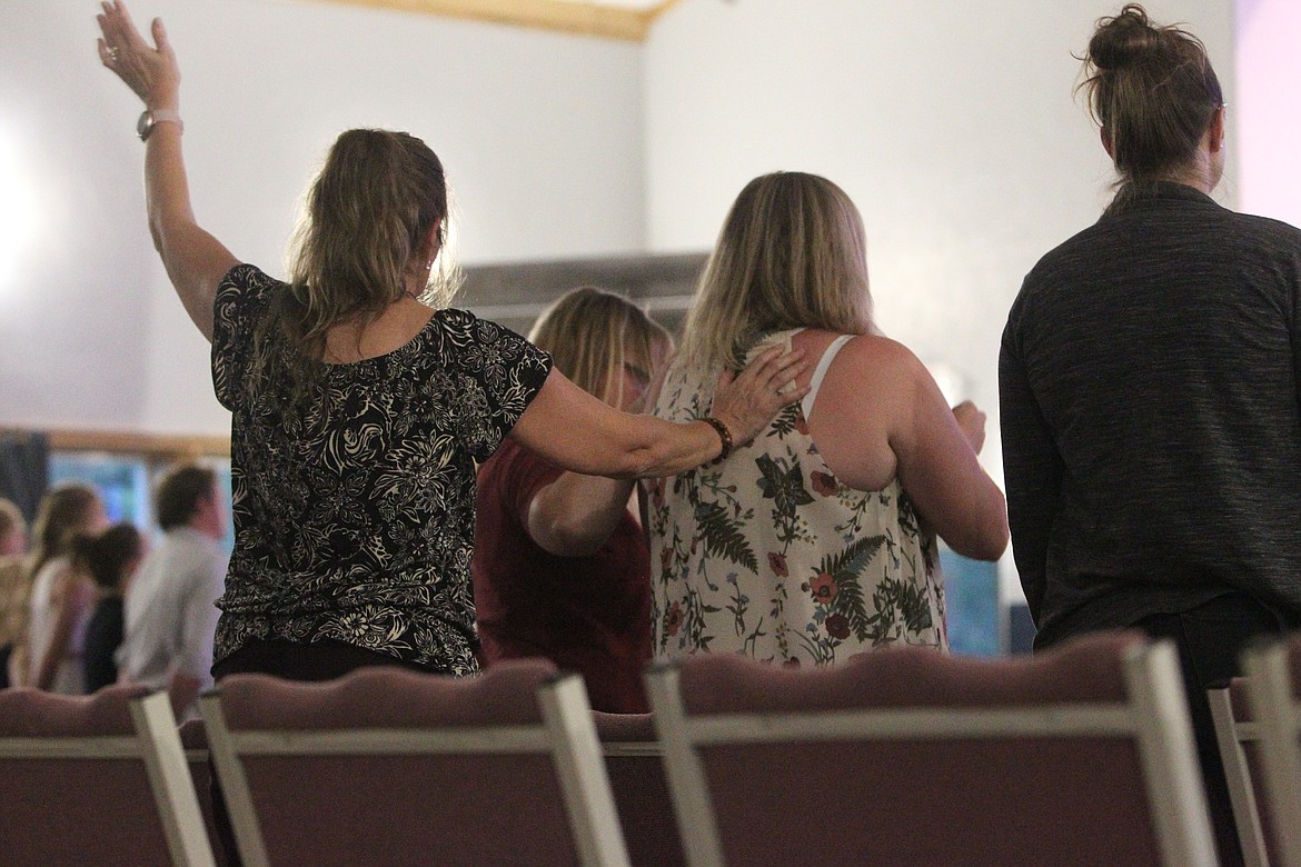 Family and friends gather around Christina Fisher, center, during a Sept. 25 prayer gathering at Troy Christian Fellowship. Christina Fisher's husband Ben Fisher is in critical condition with COVID-19 at the Boise Veterans Affairs Medical Center. (Will Langhorne/The Western News)