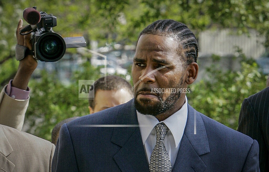 This photo from Friday May 9, 2008, shows R. Kelly arriving for the first day of jury selection in his child pornography trial at the Cook County Criminal Courthouse in Chicago. R. Kelly, the R&B superstar known for his anthem “I Believe I Can Fly,” was convicted Monday in a sex trafficking trial after decades of avoiding criminal responsibility for numerous allegations of misconduct with young women and children. (AP Photo/Charles Rex Arbogast, File)