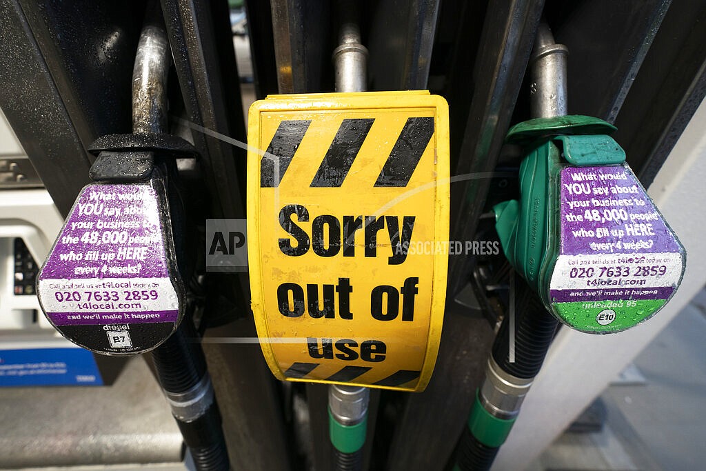An out of use sign is seen on a pump at a petrol station after the current outbreak of fuel panic buying in the UK, in Manchester, England Monday, Sept. 27, 2021. British Prime Minister Boris Johnson is said to be considering whether to call in the army to deliver fuel to petrol stations as pumps ran dry after days of panic buying. ( AP Photo/Jon Super)
