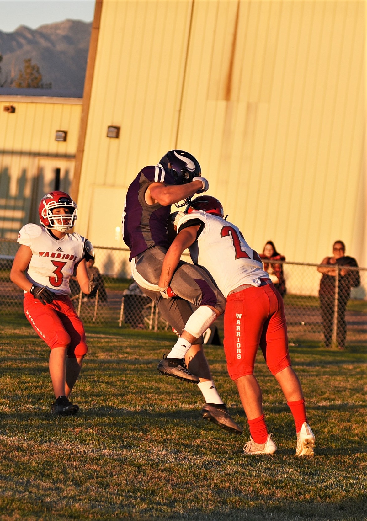 Arlee defensive back Jace Arca (22) wraps up Charlo's Braydon Zempel (8) after Zempel caught a deep pass. (Scot Heisel/Lake County Leader)