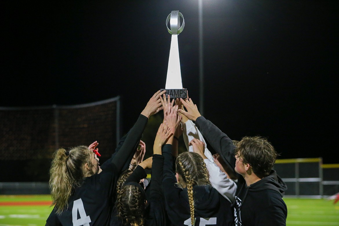 The juniors raise the championship trophy.