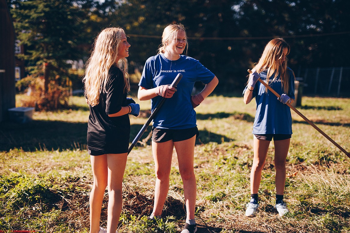 From left, Kaylie Smart, Aubree McElvany and Berkley Owens, members of the Coeur d'Alene High School varsity girls soccer team, rake a yard in Dalton Gardens for community service on Saturday. Photo courtesy of Christine Woeller