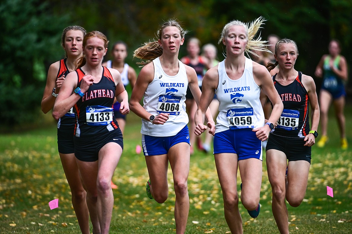 Flathead's Mikenna Conan (4132), Madelaine Jellison (4133) and Josie Wilson (4135) keep pace with Columbia Falls' Hannah Sempf (4064) and Siri Erickson (4059) at the Whitefish Invite on the South Course of Whitefish Lake Golf Club on Tuesday, Sept. 28. (Casey Kreider/Daily Inter Lake)