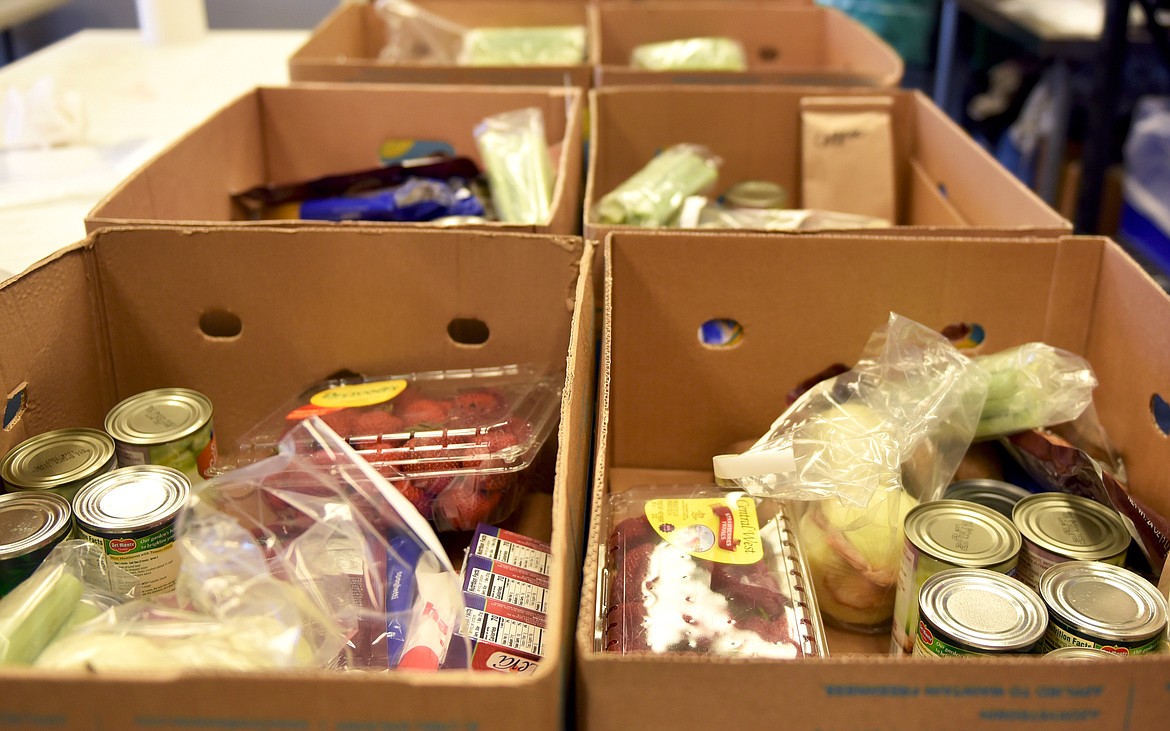 North Valley Food Bank volunteers prepared boxes of food prior to a recent food distribution day at the food bank in Whitefish. (Whitney England/Whitefish Pilot)