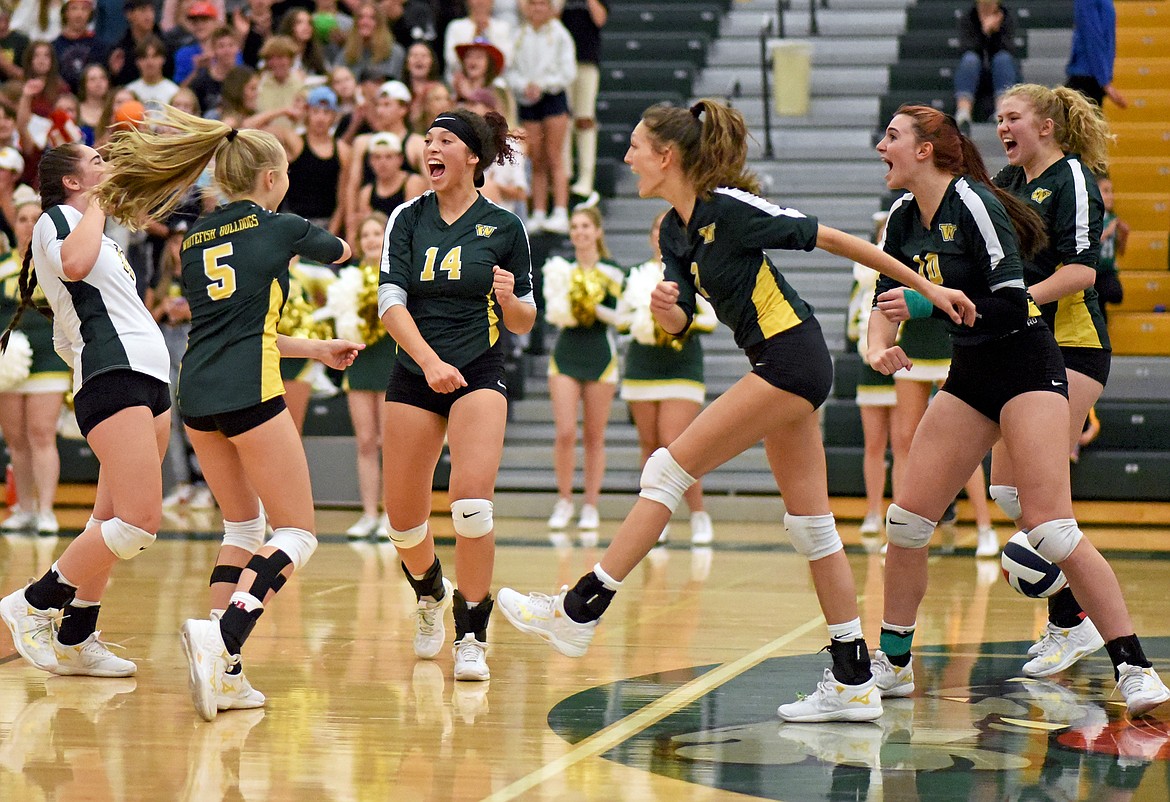 The Lady Bulldogs volleyball team celebrates an ace by Kaydence Blackwell (5) in the first set of a match against Polson on Thursday. (Whitney England/Whitefish Pilot)