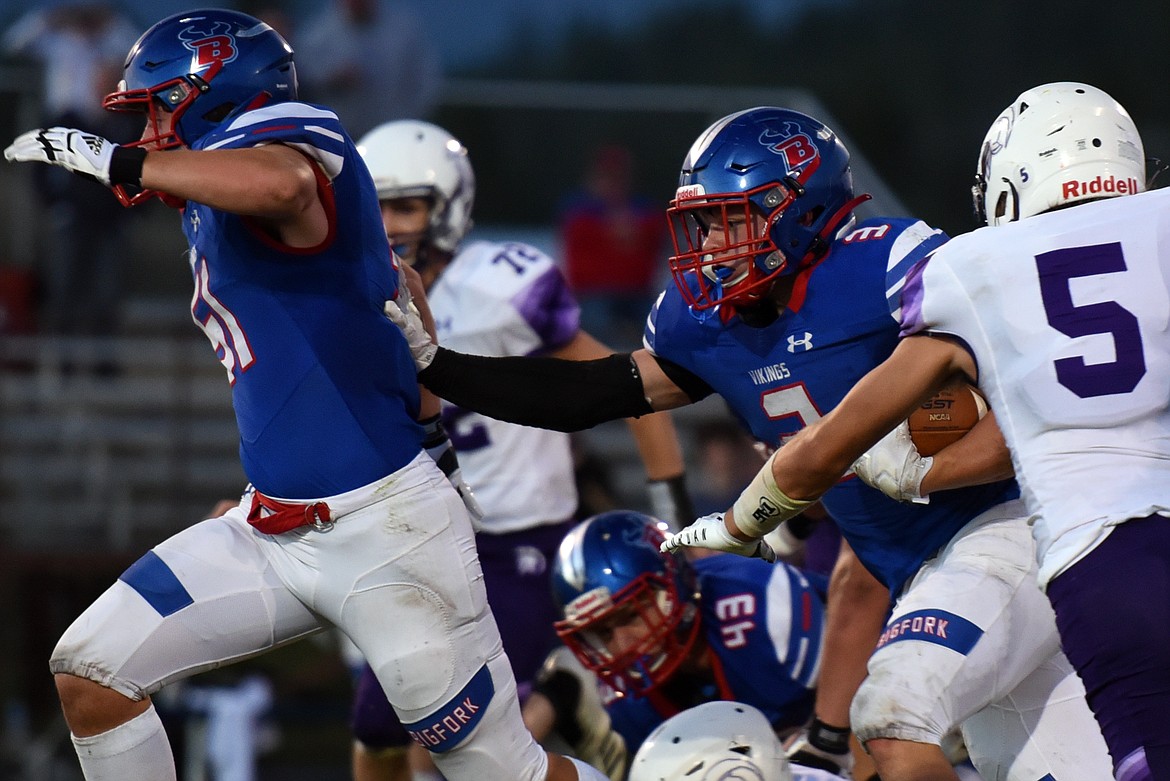 Bigfork running back Levi Taylor runs behind the block of lineman Jordan Betts. (Jeremy Weber/Bigfork Eagle)