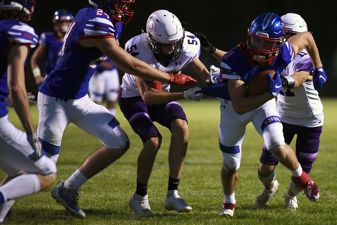 Bigfork's George Bucklin evades Whitehall defenders in the second quarter Friday. (Jeremy Weber/Bigfork Eagle)