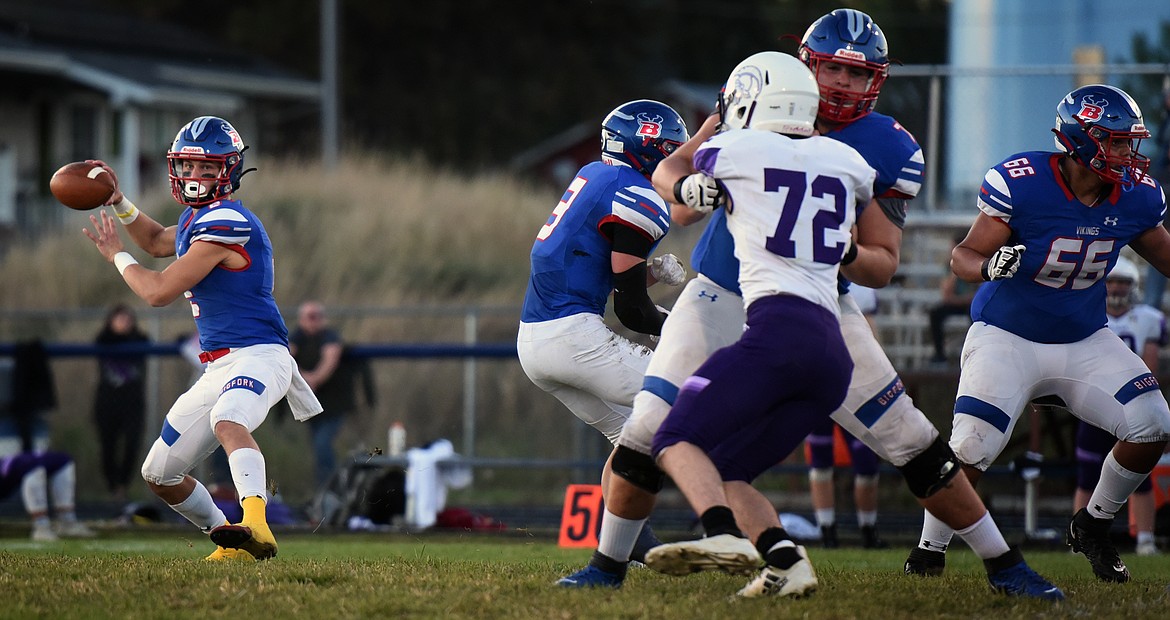 Bigfork's offensive line holds off the Whitehall defense as quarterback Patrick Wallen looks for a receiver Friday. (Jeremy Weber/Bigfork Eagle)