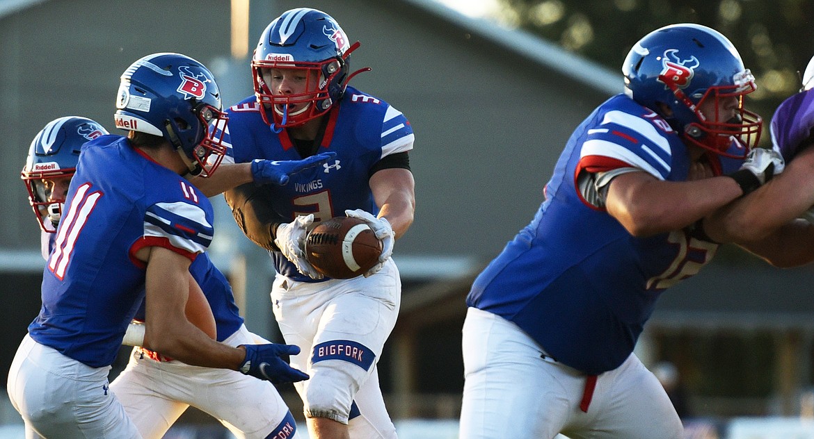 Bigfork running back Levi Taylor hands off to fellow running back George Bucklin in the first quarter against Whitehall Friday. (Jeremy Weber/Bigfork Eagle)