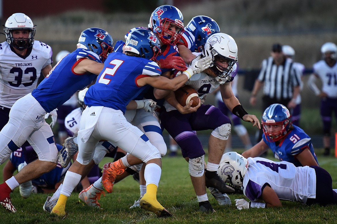 The Bigfork defense swarms Whitehall quarterback Miles Hoerauf in the second quarter Friday. (Jeremy Weber/Bigfork Eagle)