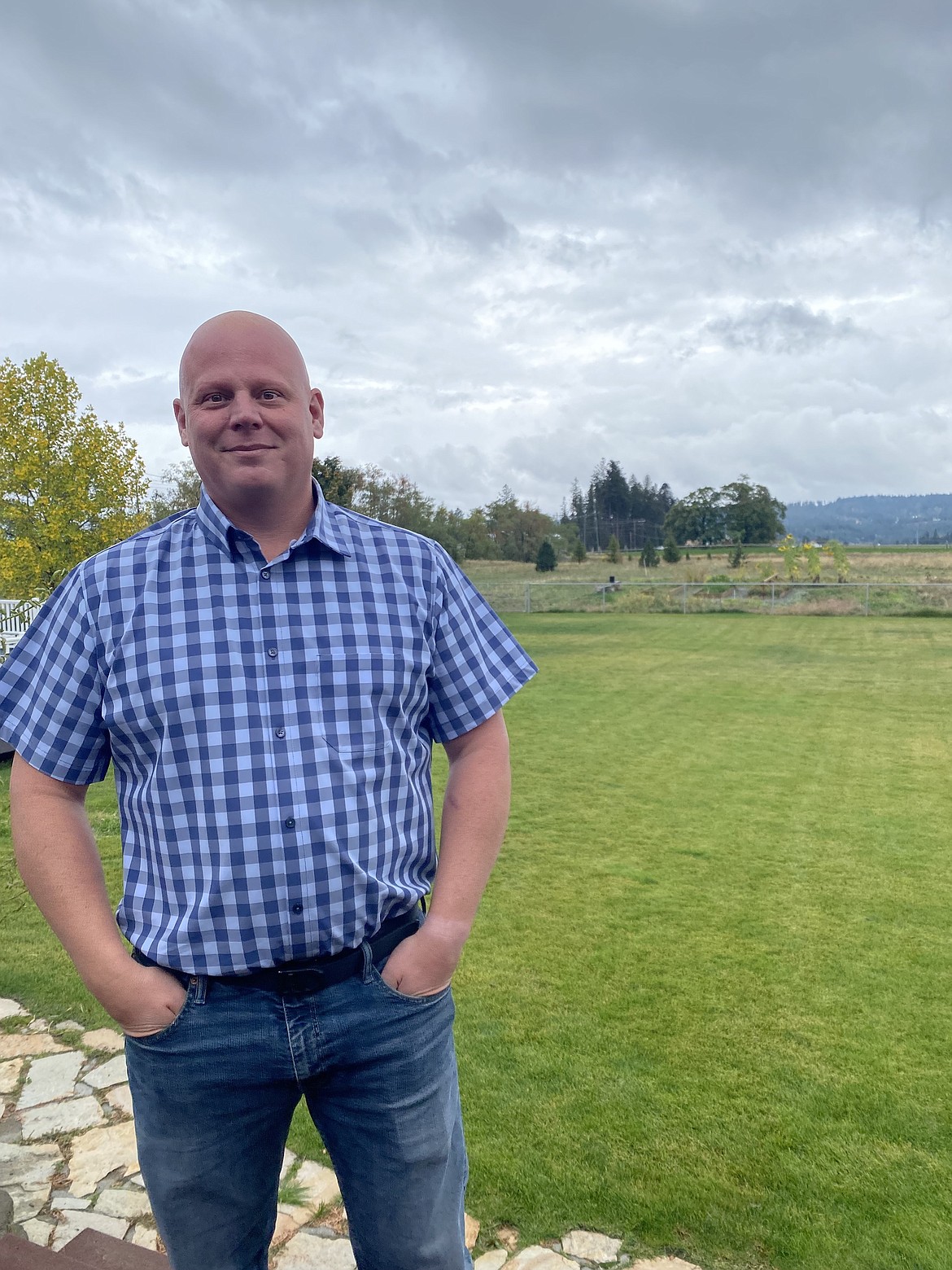 Brickert Estates resident Brian Rogers stands in front of his backyard. All of his property will be taken for the Huetter Corridor project once construction begins. A four lane highway and an expansion of Huetter to three lanes are part of the plan.