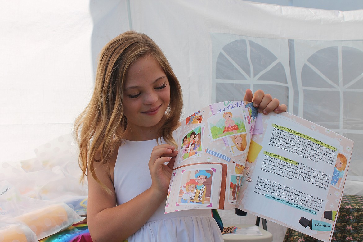 Sofia Sanchez, 12, shows pages from the book she inspired, “You Are Enough,” encouraging people with Down syndrome or other disabilities to celebrate themselves.