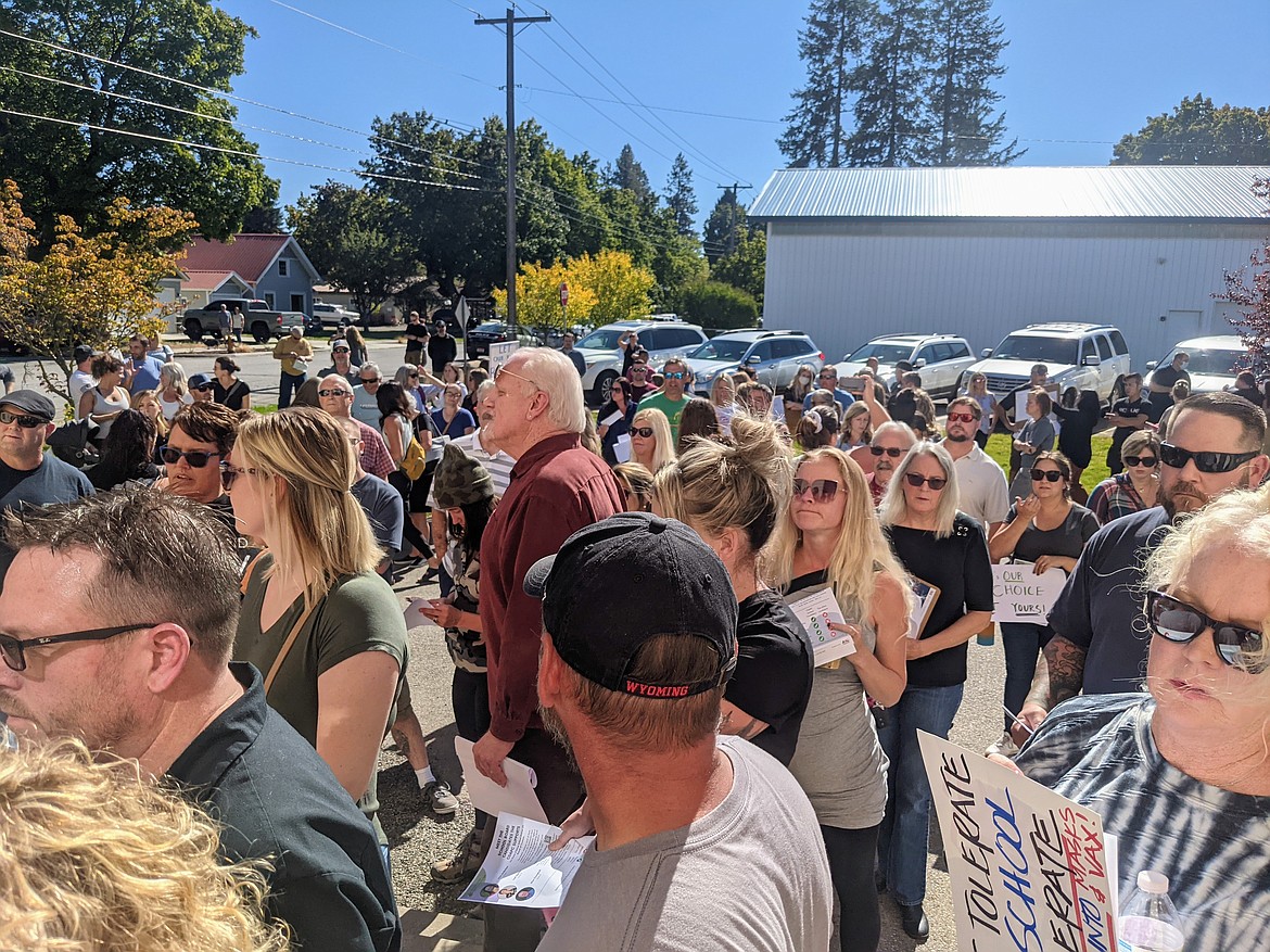 A crowd of around 200 protesters chanted, waved signs, and shouted at police at the special meeting of the Coeur d'Alene School District Board of Trustees to discuss the mask mandate on Friday at the Midtown Center Meeting Room in Coeur d'Alene. The meeting was cancelled and will not be rescheduled. CHANCE WATSON/Press