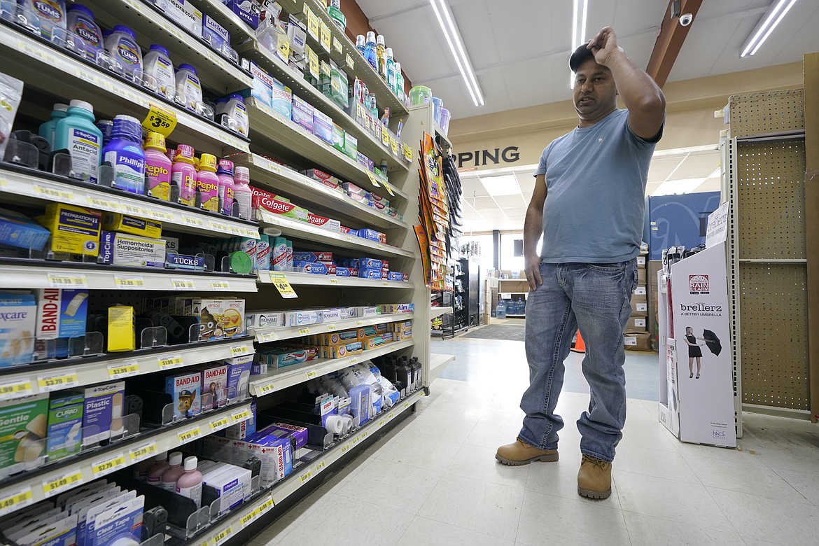 Ricky Maan looks at shelves displaying first-aid items, Monday, Sept. 27, 2021, in the grocery store his family owns in Chester, Mont., near the scene where an Amtrak train derailed Saturday, killing three people and injuring others. When the crash happened, Maan and others in his family rushed to the scene with first-aid and food supplies taken right from the shelves of their store. (AP Photo/Ted S. Warren)