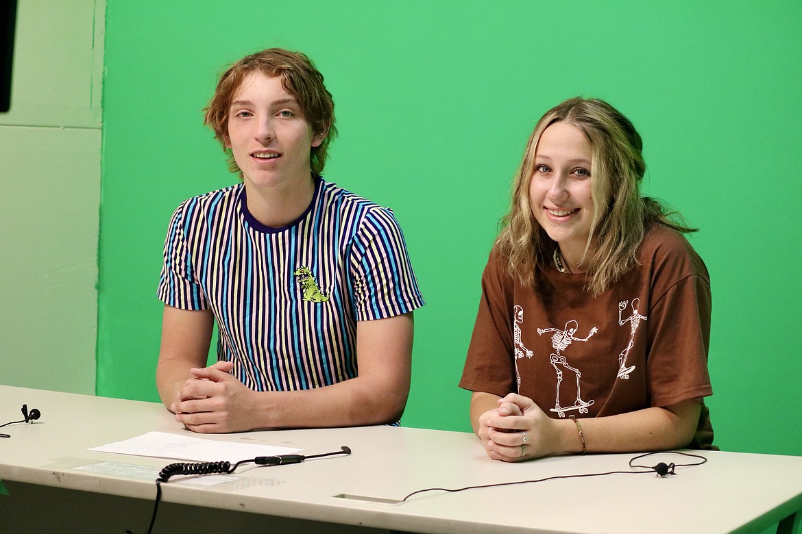 Timberlake High School seniors Tanner Menti and Sami Wilfong sit in front of the green screen as they prepare to start the daily live broadcast for the school, a short segment around five to seven minutes that lists birthdays, a smile of the day photo, special school events, lunch menu choices and more, and ends with leading the school in the Pledge of Allegiance. HANNAH NEFF/Press