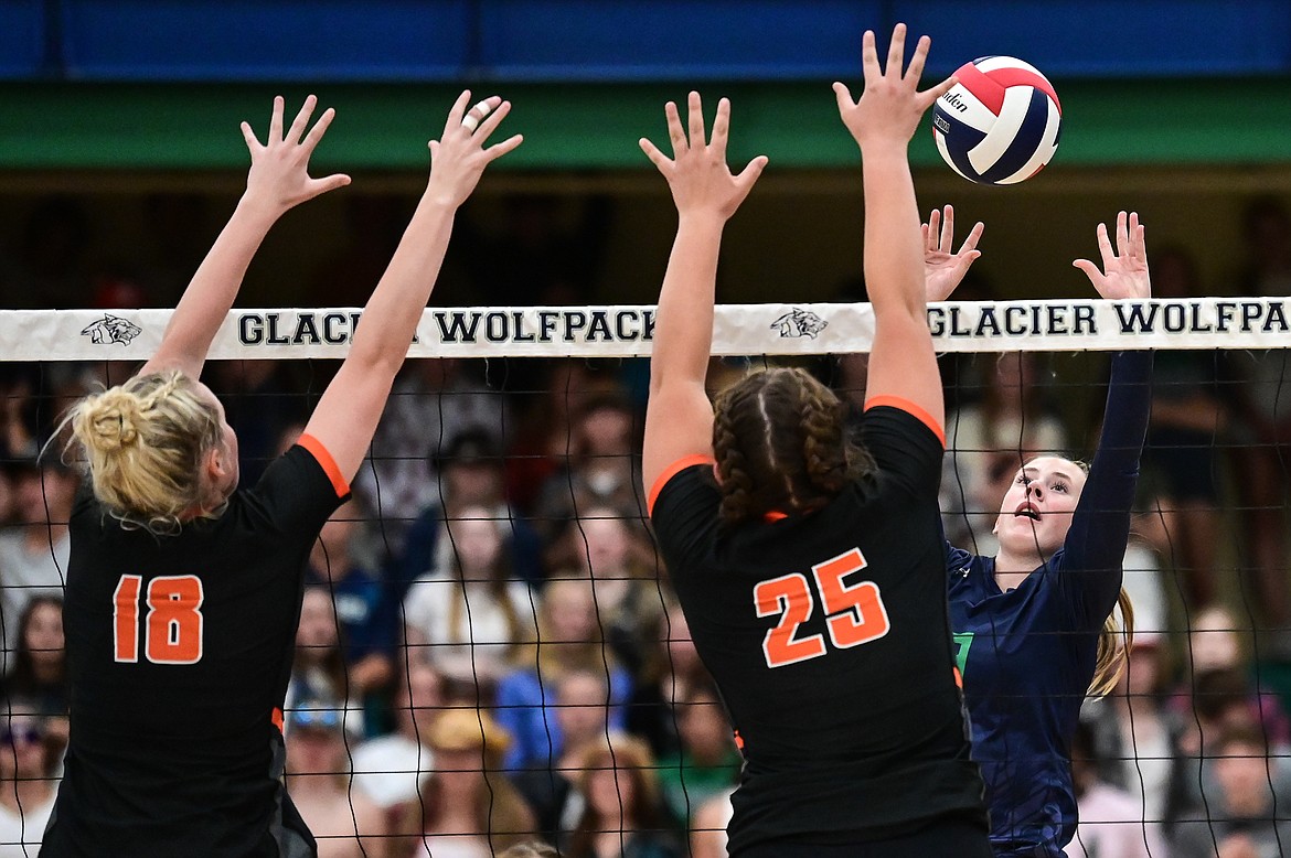 Glacier's Sarah Downs (9) goes up for a kill against Flathead's Maddy Moy (18) and Savanna Sterck (25) at Glacier High School on Thursday, Sept. 30. (Casey Kreider/Daily Inter Lake)