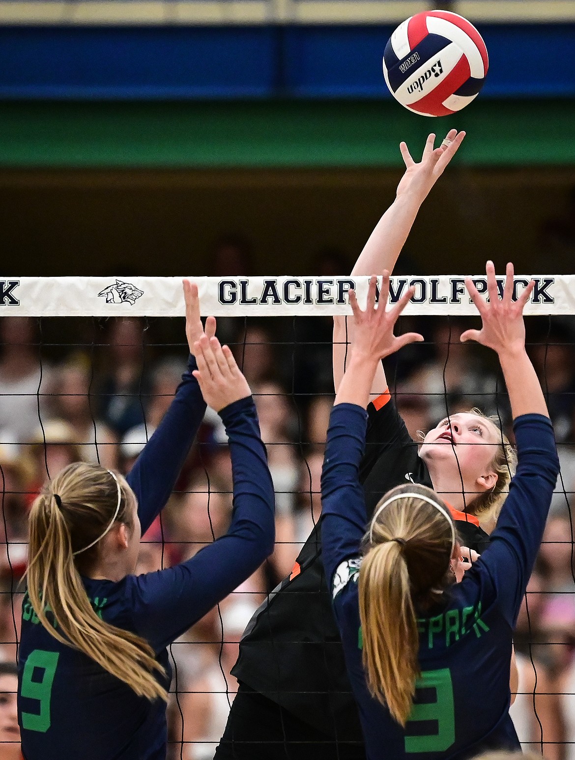 Flathead's Maddy Moy (18) goes up for a kill against Glacier's Sarah Downs (9) and Haven Speer (3) at Glacier High School on Thursday, Sept. 30. (Casey Kreider/Daily Inter Lake)