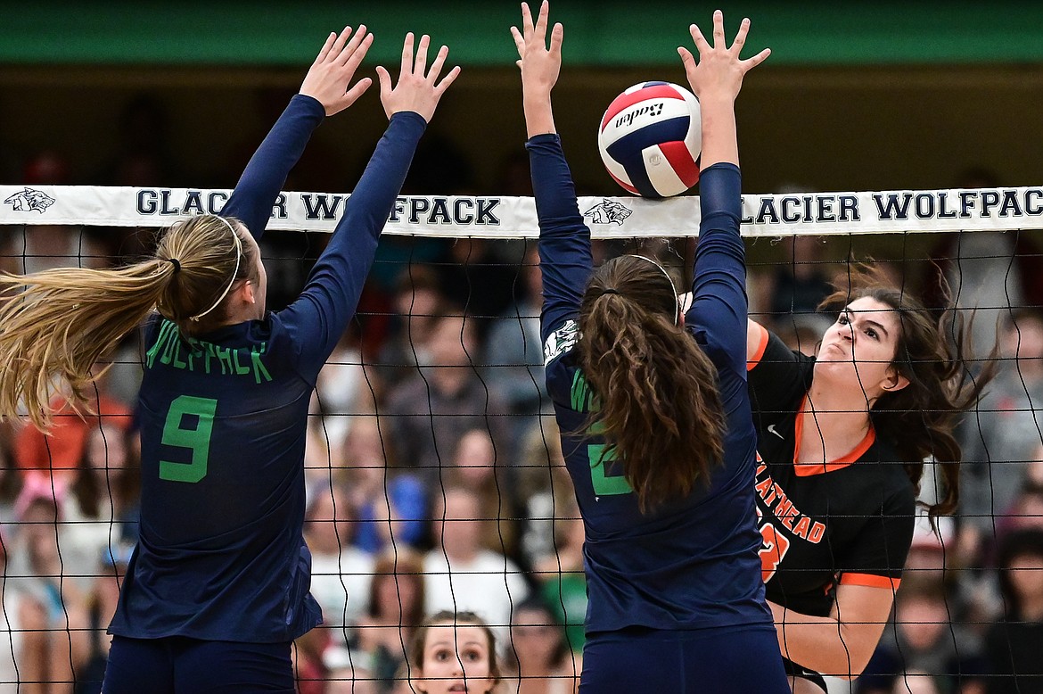 Flathead's Savanna Sterck (23) goes up for a kill against Glacier's Sarah Downs (9) and  Madeline Davis (22) at Glacier High School on Thursday, Sept. 30. (Casey Kreider/Daily Inter Lake)