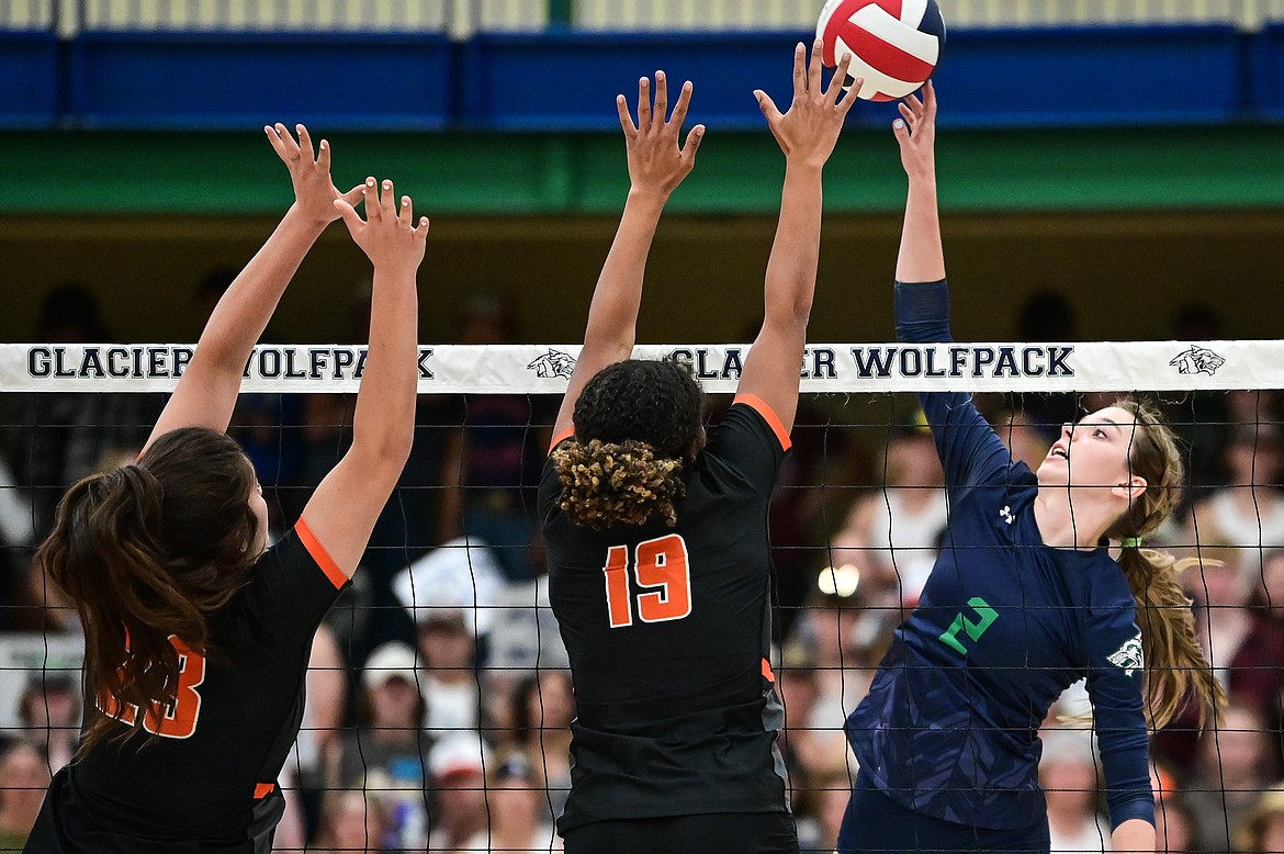 Glacier's Sidney Gulick (2) goes for a kill against Flathead's Savanna Sterck (23) and Akilah Kubi (19) at Glacier High School on Thursday, Sept. 30. (Casey Kreider/Daily Inter Lake)