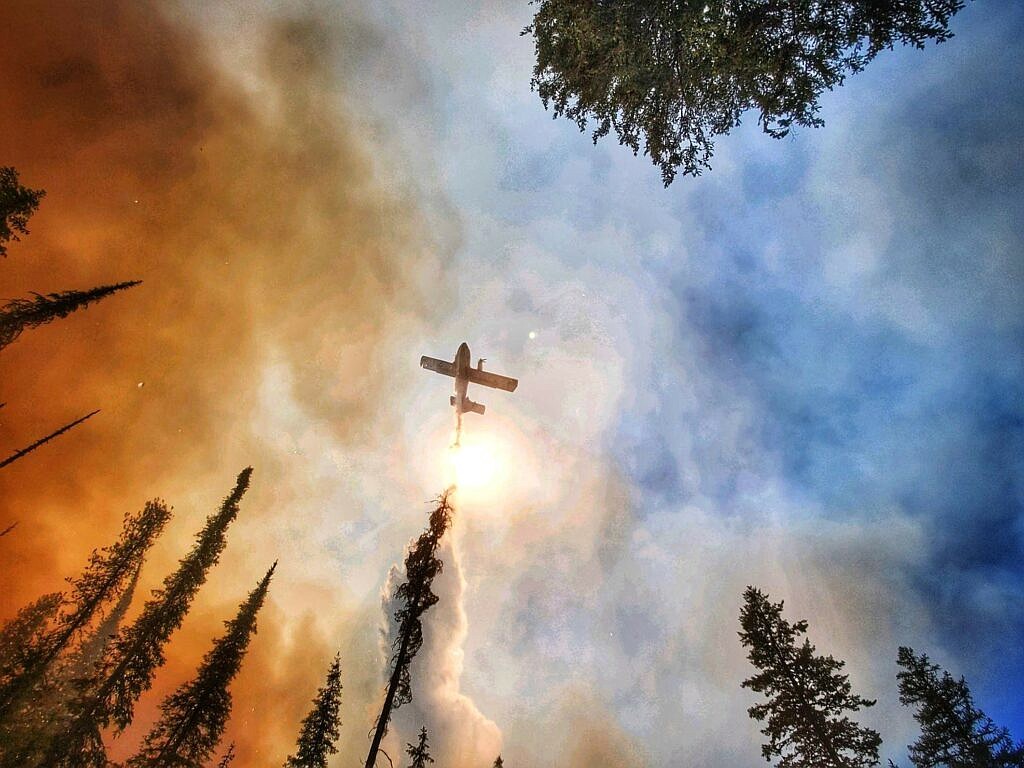 A large airtanker makes a water drop on the 2021 Summit Trail Fire in Washington.