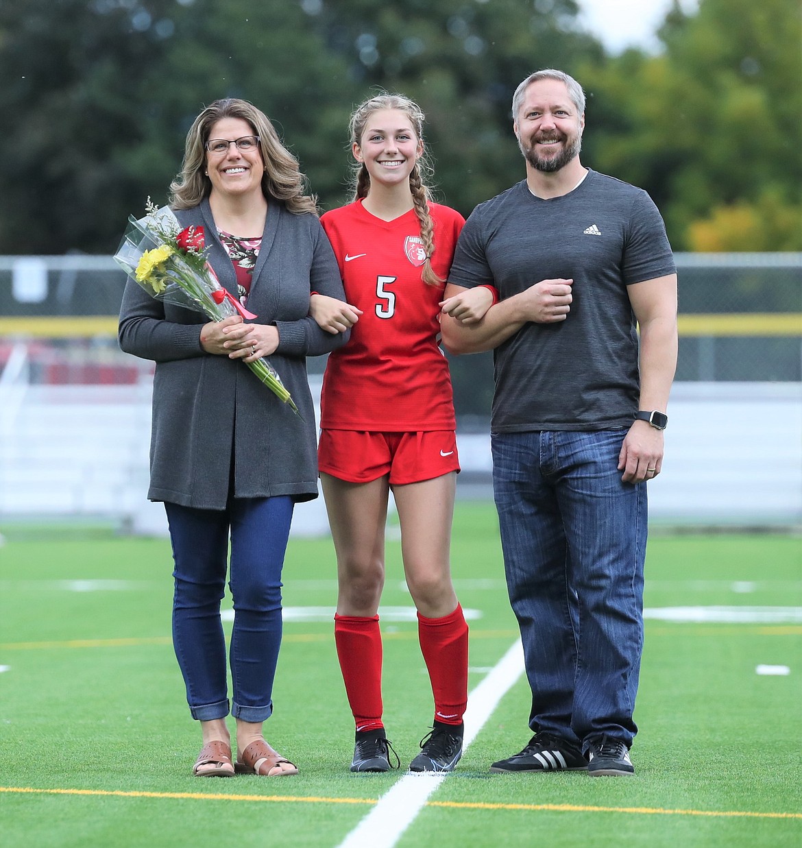 Ashlee Webster poses for a photo with her family on Senior Night.