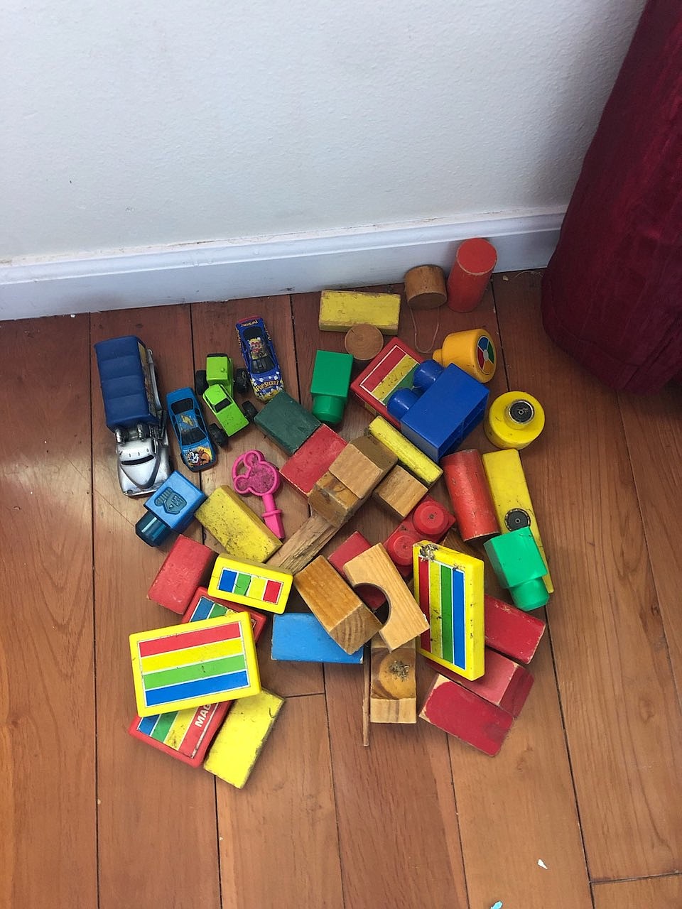 A collection of items Jacob Miller pulled out of a vent in a home, including toy cars and building blocks.